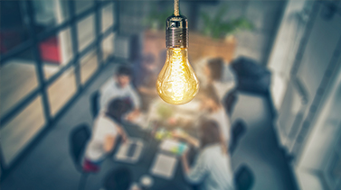 Focused shot of a lightbulb on an office room