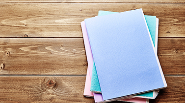 A series of papers on a wooden table